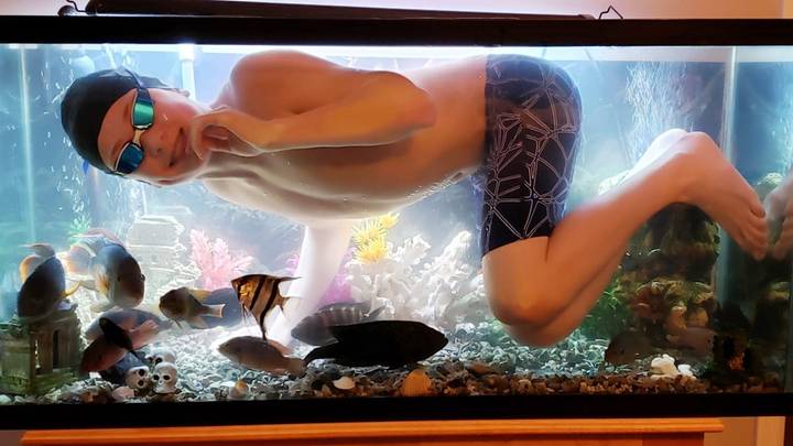 Teen Who 'Misses Swimming' During Pool's Coronavirus Lockdown Takes Dip In Dad's Fish Tank