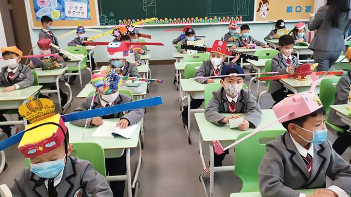 Trainees In China Wear Homemade Social Distancing Hats As They Return To School